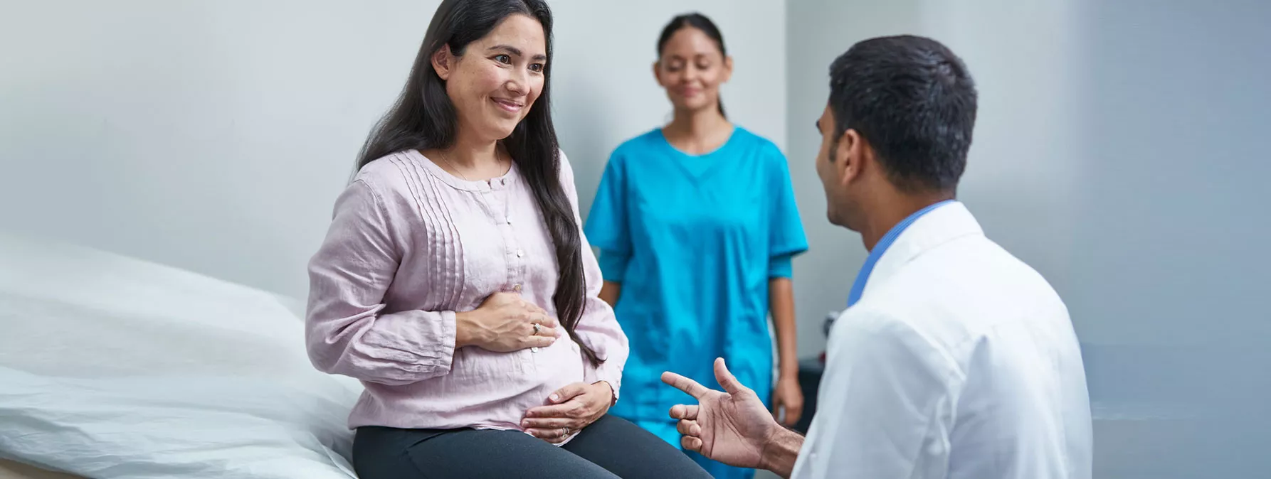 Pregnant woman and clinician image