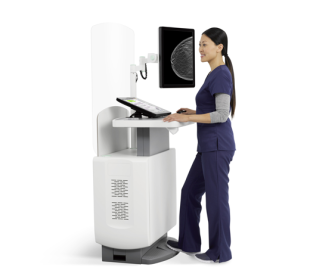 Technician working on medical machine on white background